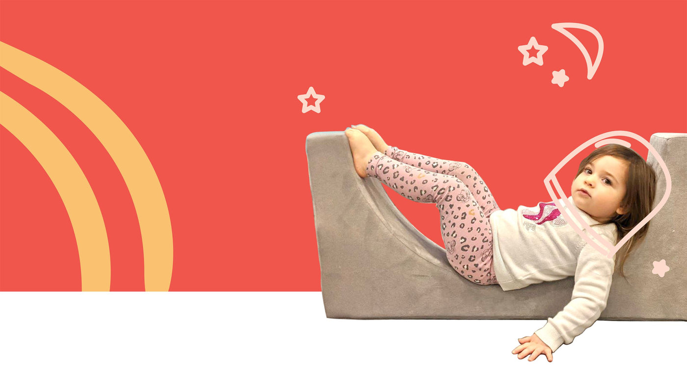 toddler girl in grey arch play couch piece