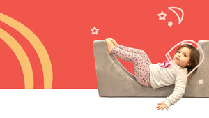 toddler girl in grey arch play couch piece